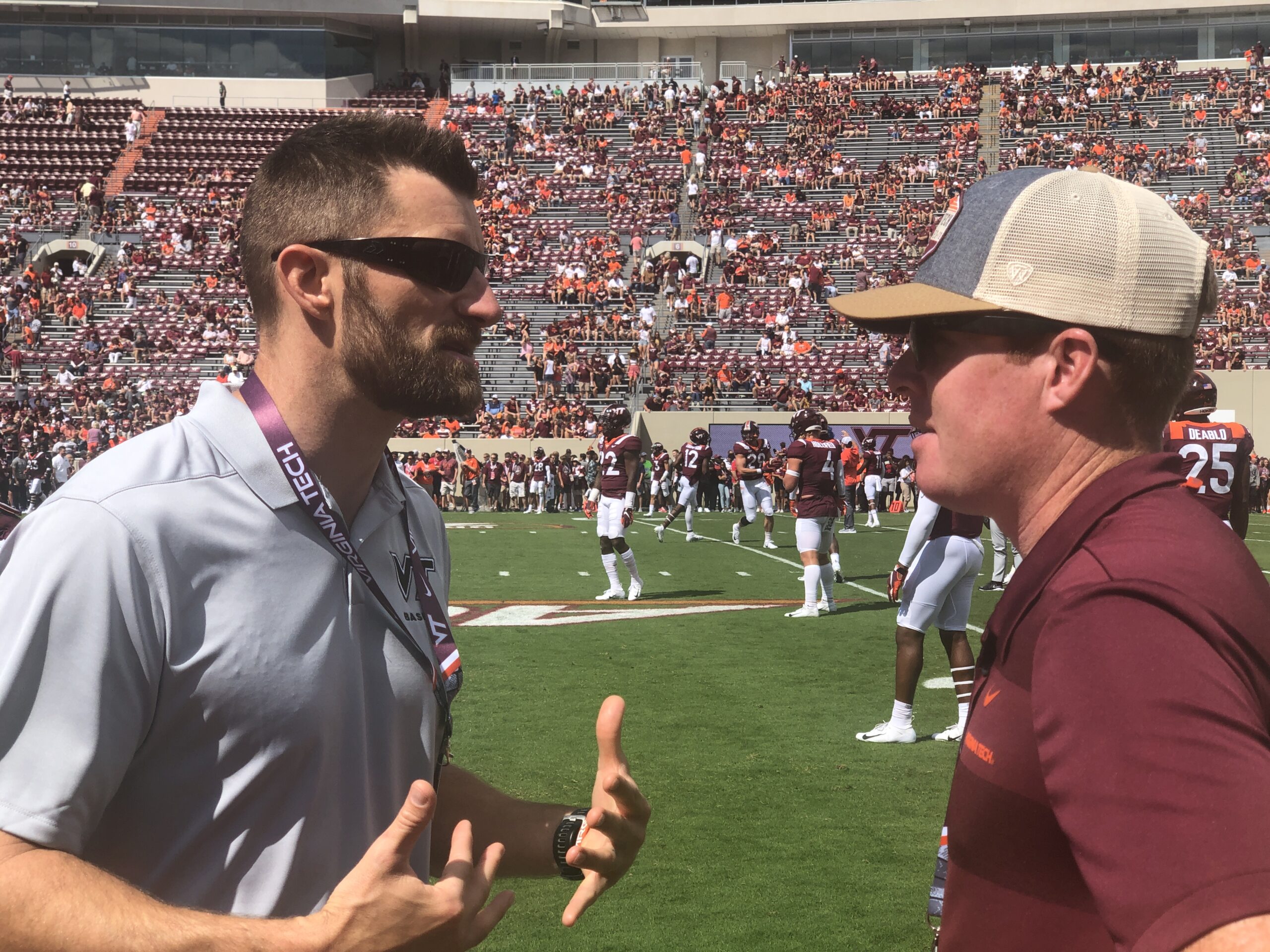 Brian Cain discussing release routines with a coach pre-game